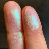 Close up finger swatches on fair skin ton eof Kaleidoscope Glitter Multichrome Eyeshadow