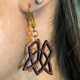 Purple Heart Clionadh symbol earrings being worn